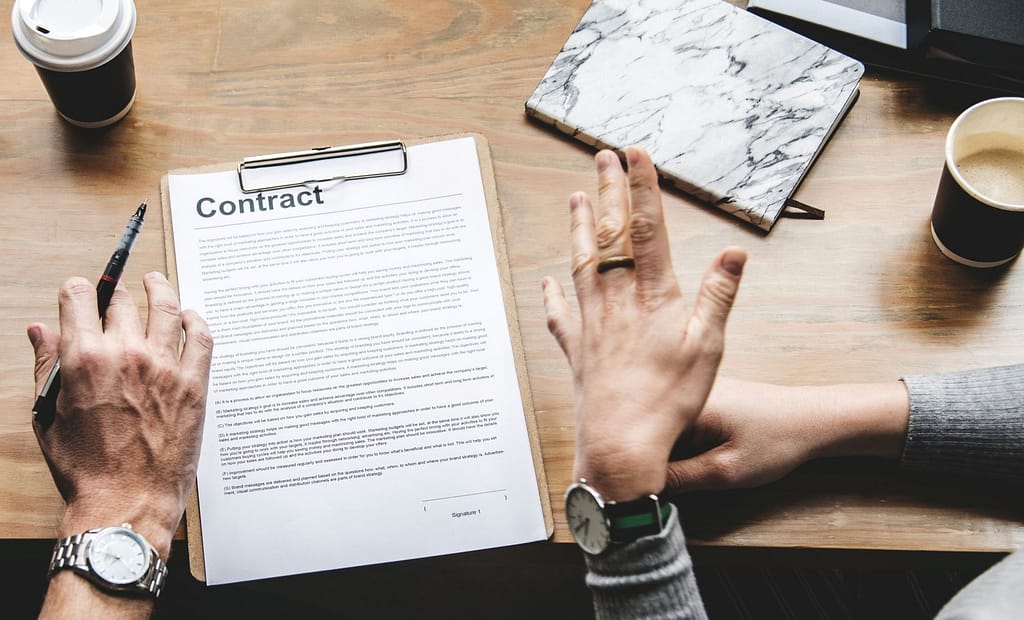 Paper titled Contract on a board on a table